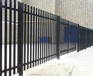 Heavy-duty palisade fencing providing secure boundary enclosure